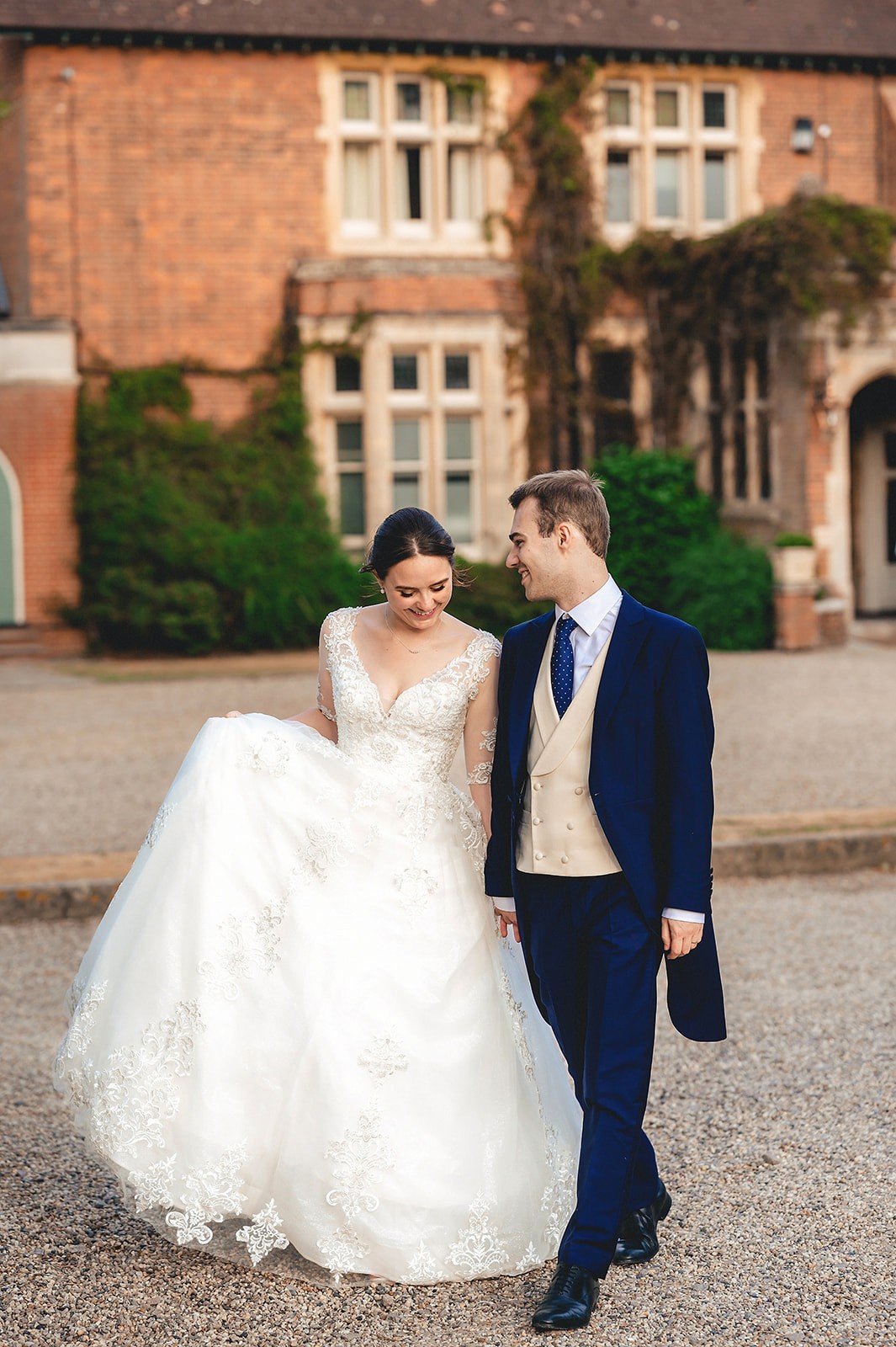 Elizabeth and Henry walking together outside their wedding venue