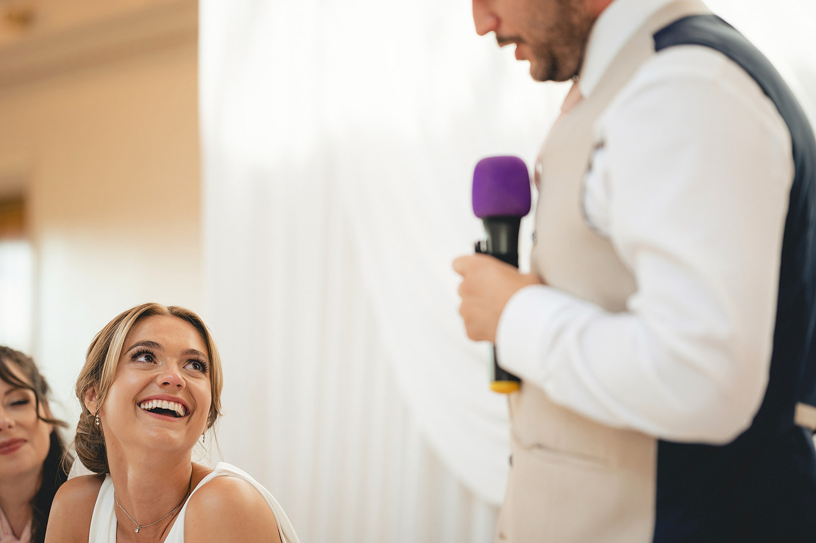 Danielle smiling up at Lee during his wedding speech