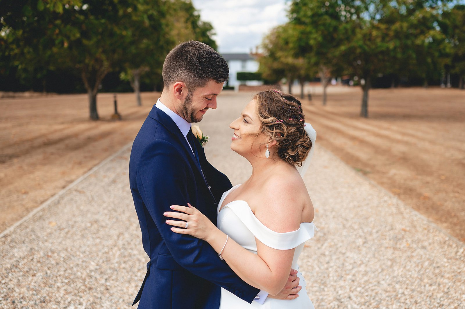 A couple smiling together during their wedding portraits
