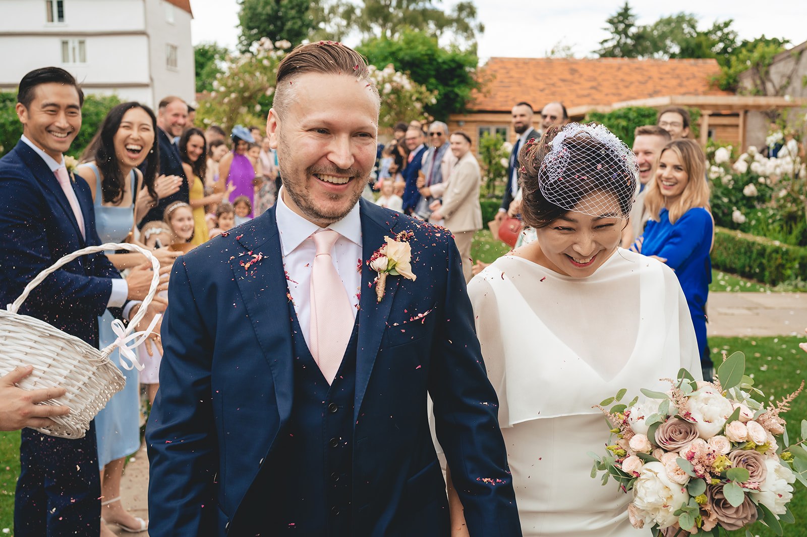 A newly married couple walking through confetti