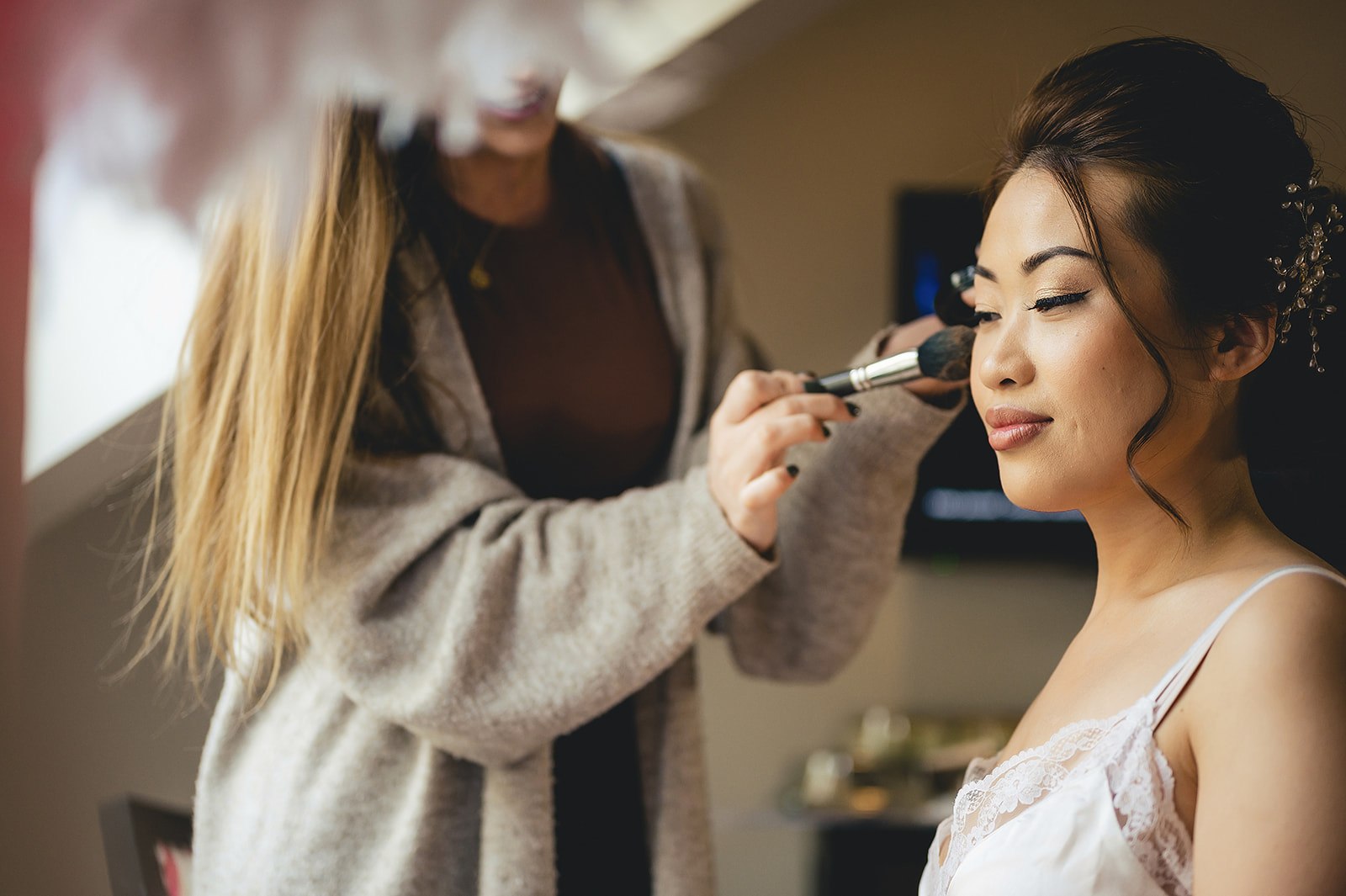 A bride having her makeup finished