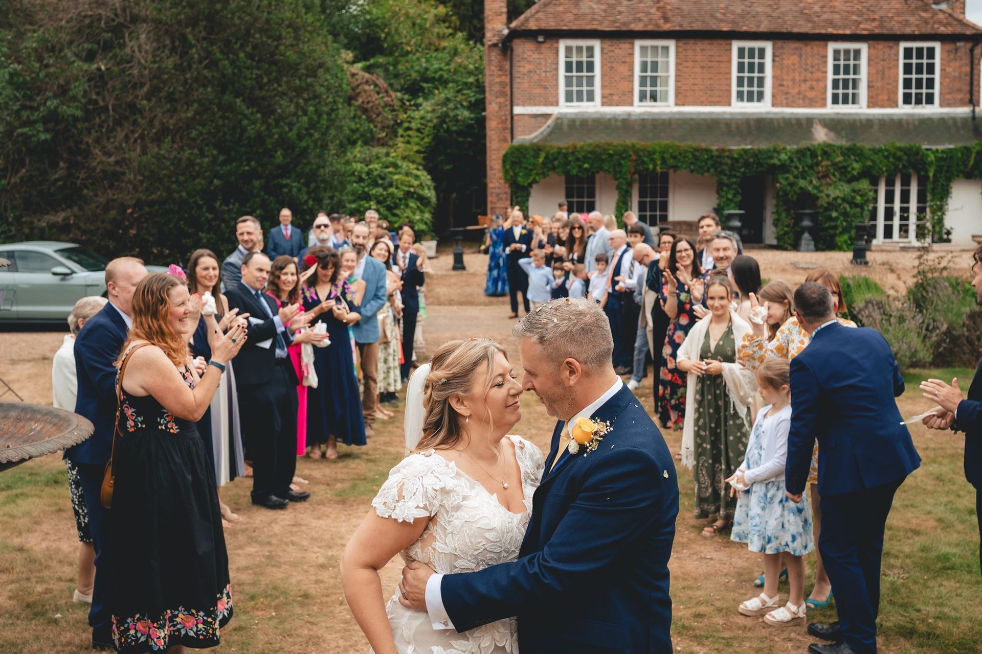 Guests celebrating with a couple outdoors
