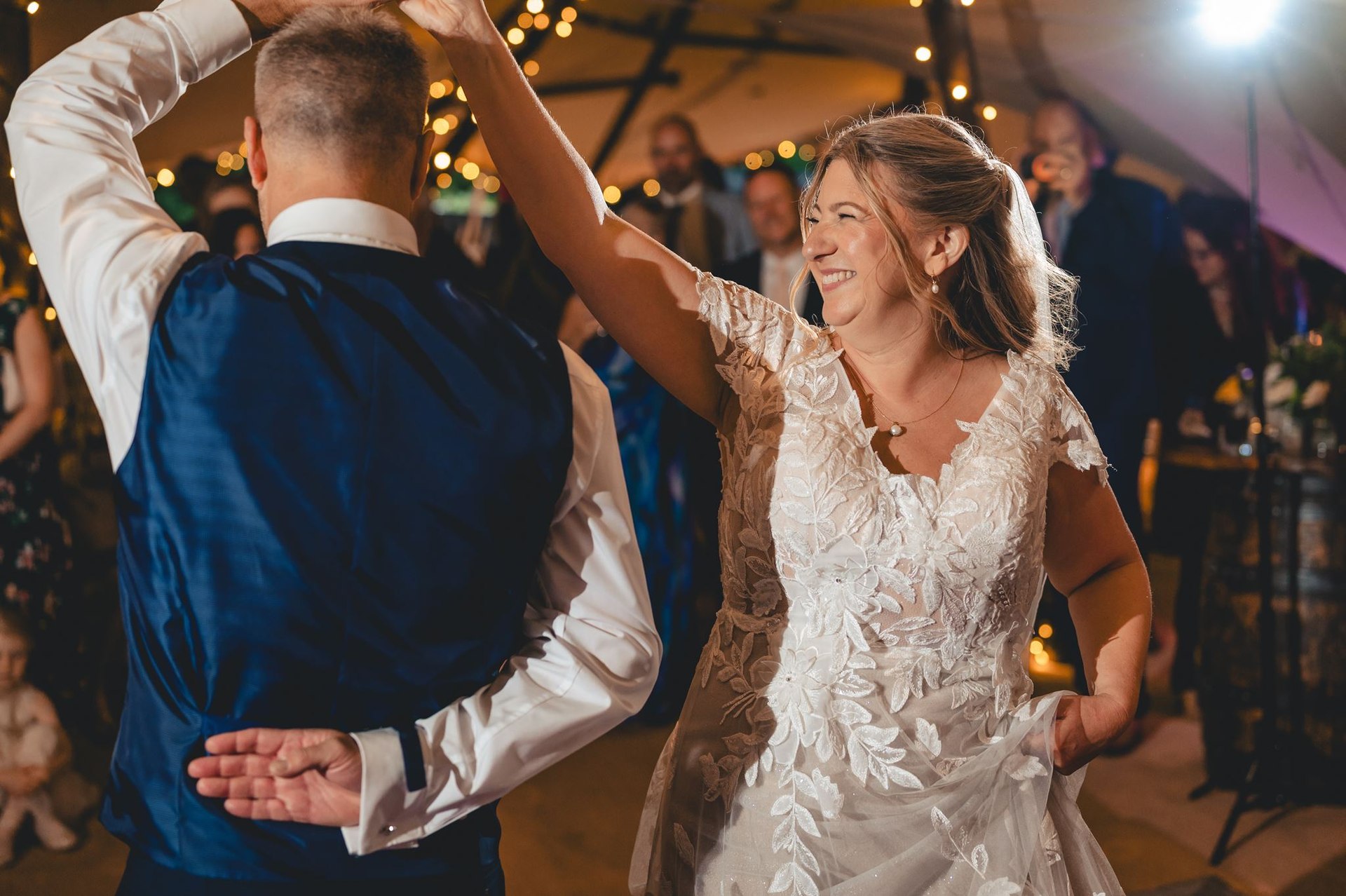 A couple dancing with guests in the evening