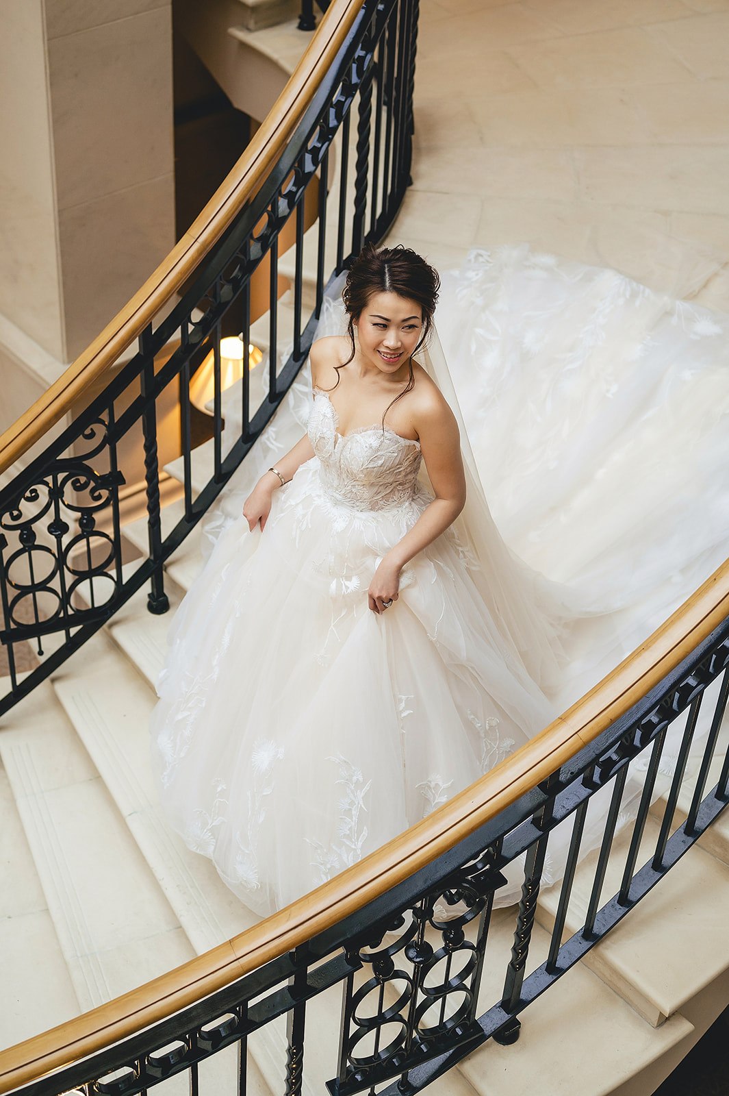 A bride on the staircase at The Landmark London