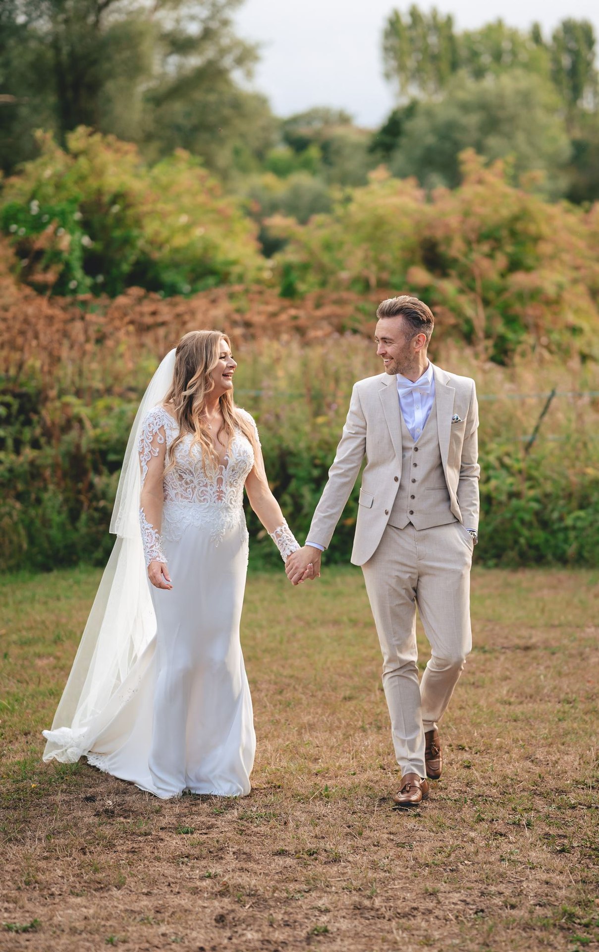 A couple walking together through a garden